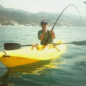 Justin Berfield fishing in a kayak-type canoe