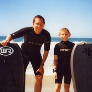 Erik Per Sullivan and his dad surfing