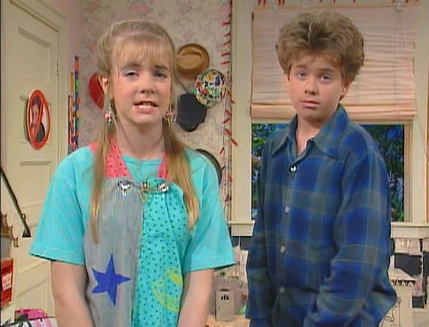 Clarissa and Sam turning to the viewer in mid-dialogue